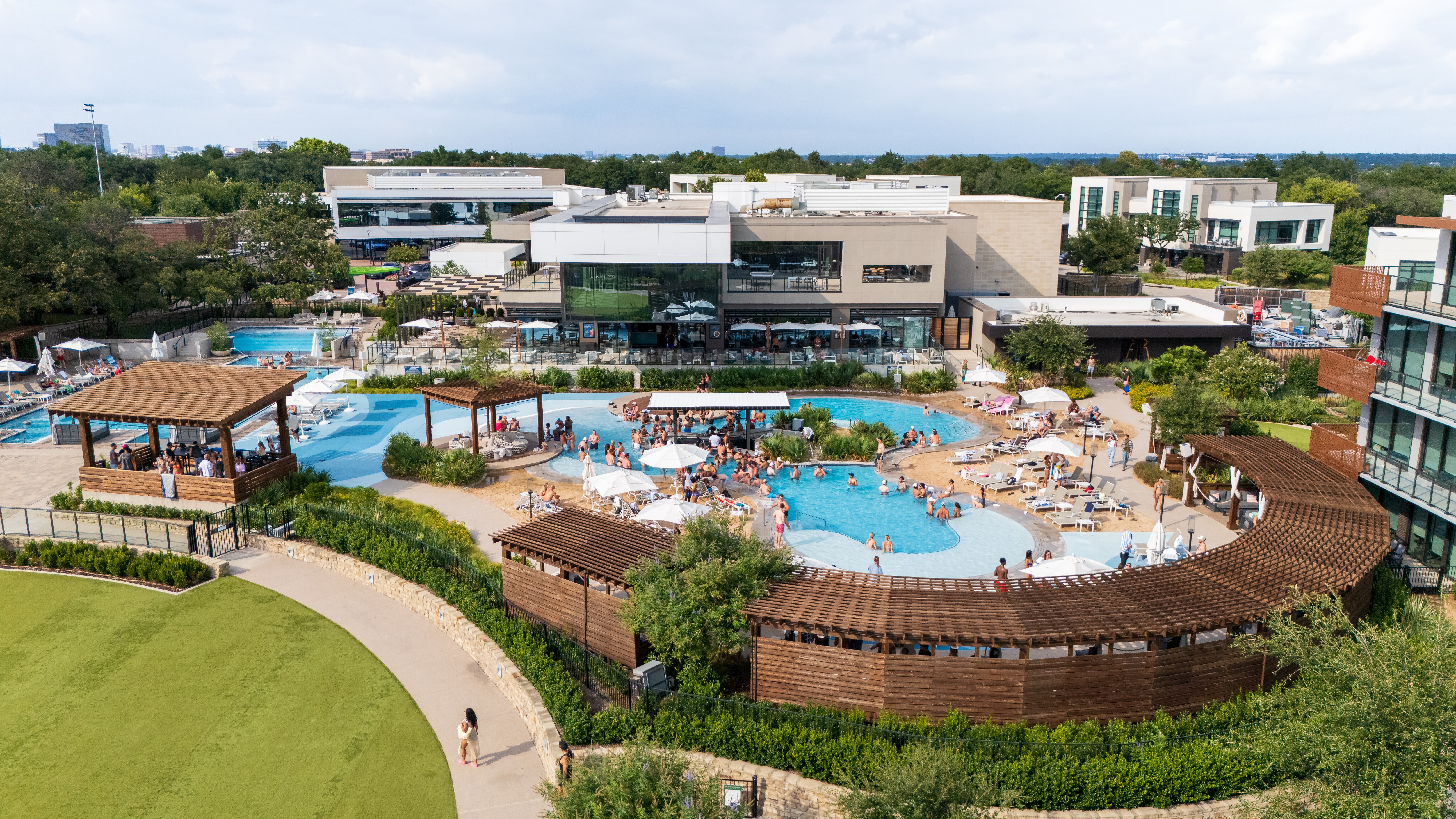 Resort-style pool in Dallas at Village Beach Club with lounge seating and cabanas