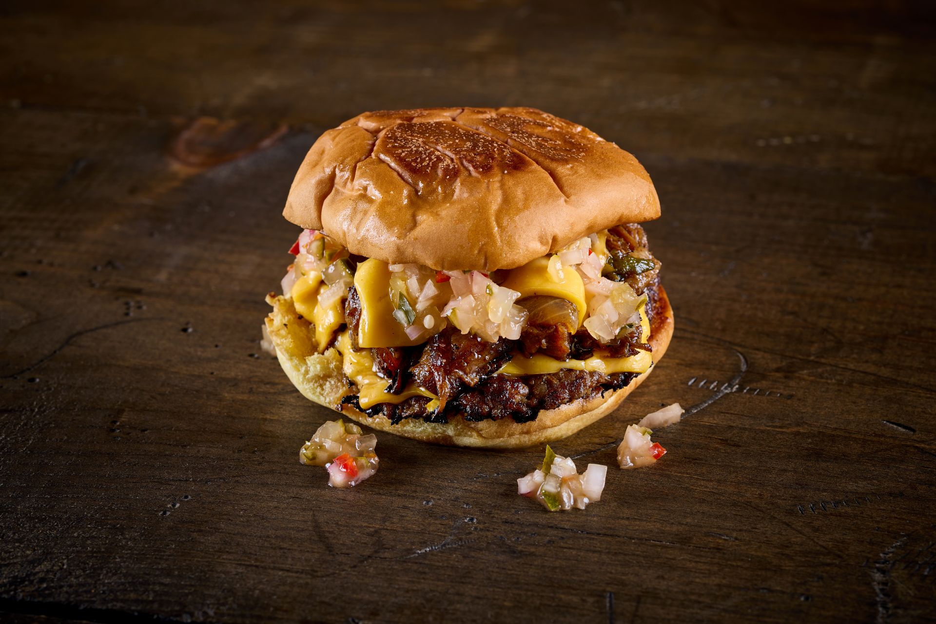 Taco Bamba's burger with brisket chop chop patty, American cheese, chili relish, Bamba smoke sauce.
