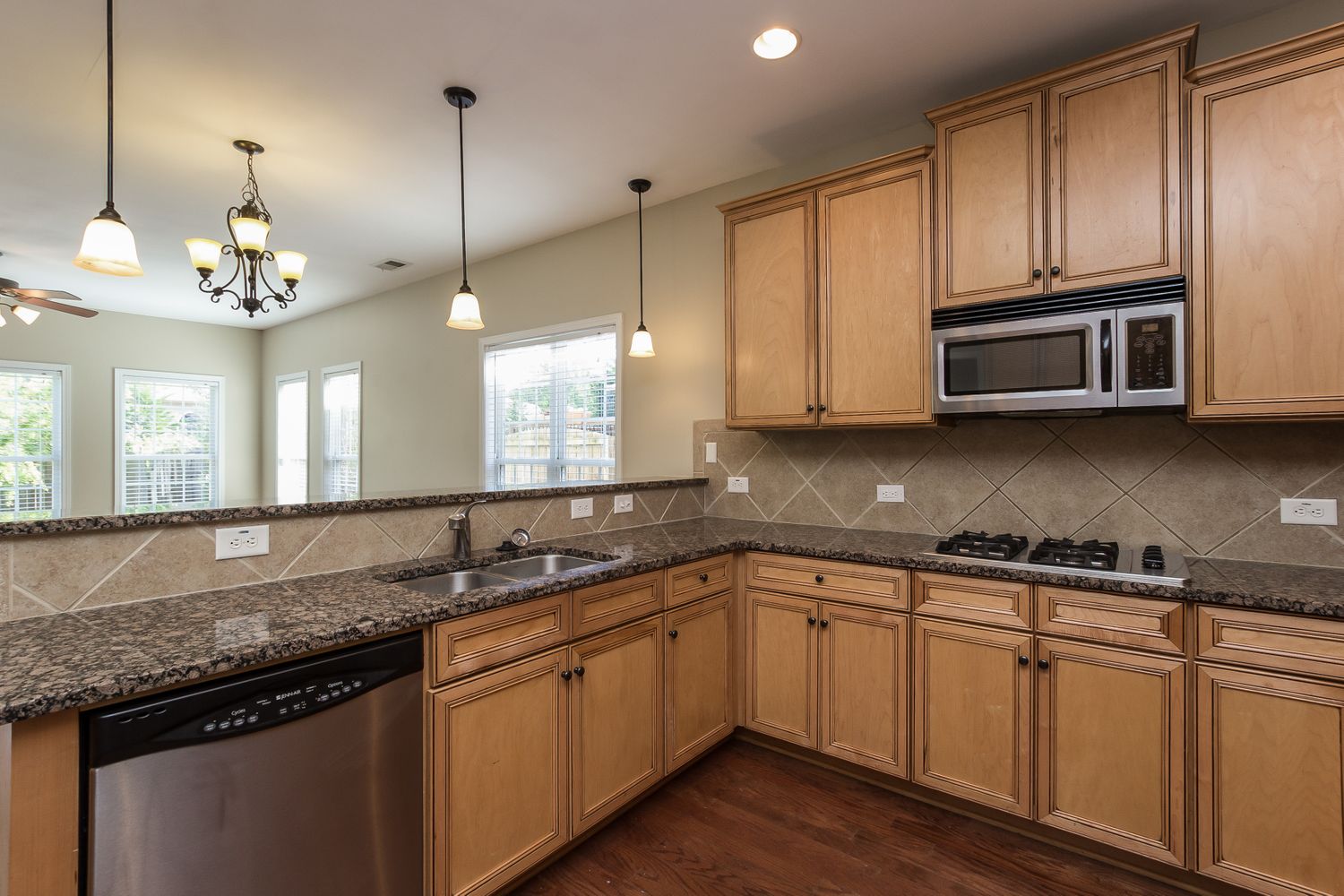 Kitchen with stainless steel appliances and recessed lighting at Invitation Homes Atlanta.