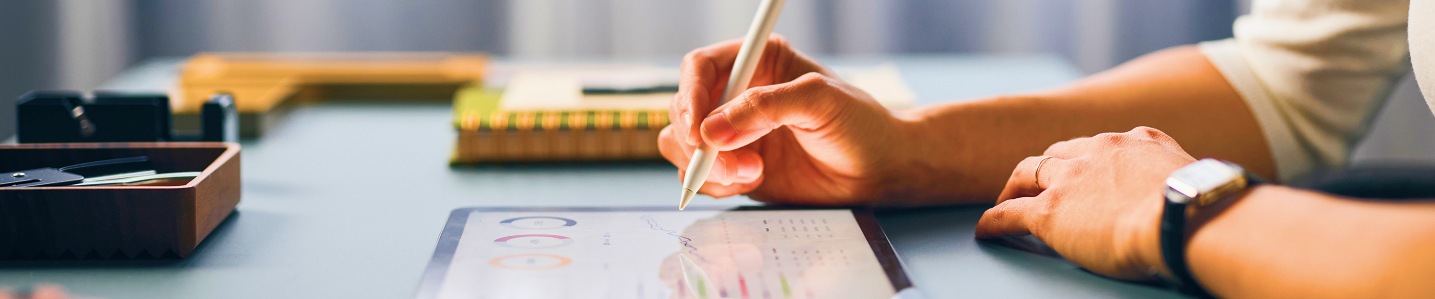 Close up of an investment advisor reviewing files on their iPad.