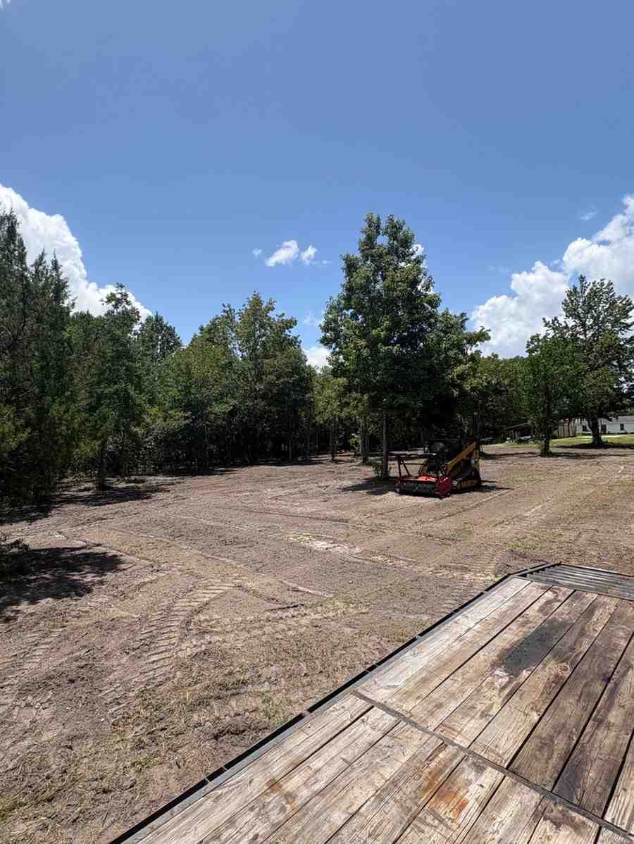 Large open work area created through land clearing and grading services, providing a stable foundation for future construction, landscaping improvements, drainage enhancements, and property development projects.