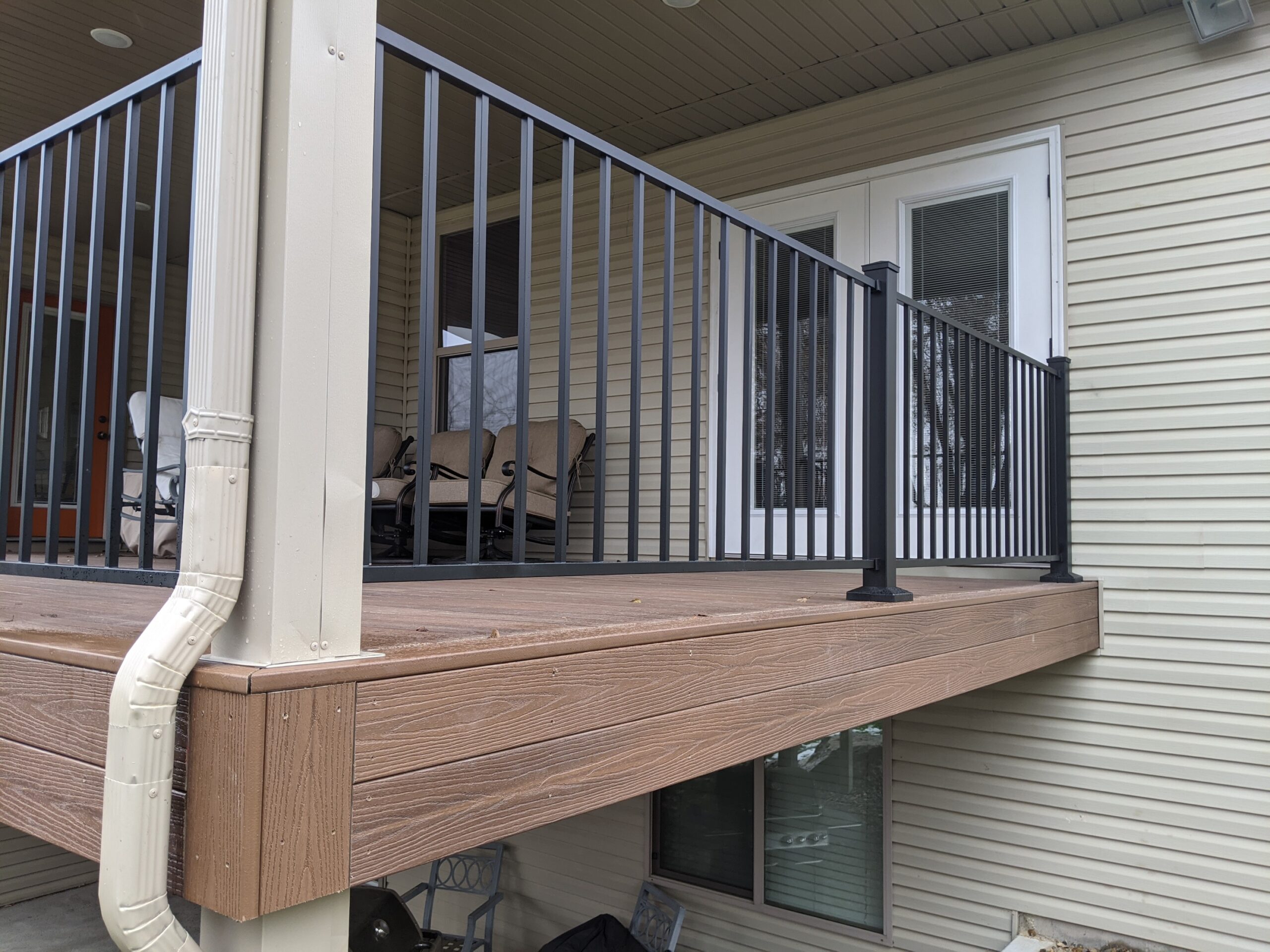 Upgrade your home's exterior with a stunning, low-maintenance composite deck. This custom project by DeckPro LLC pairs durable wood-tone composite decking with modern black metal railing for a clean, sophisticated look built to withstand Idaho weather.