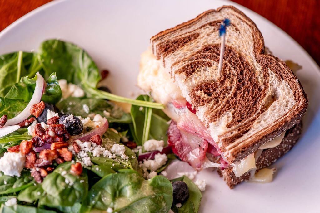half reuben sandwich & small cranberry pecan salad