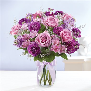 Shades Of Purple™
Every shade of purple in our radiant bouquet will bring joy & delight to the people you love. A rich gathering of blooms, hand-arranged by our skilled florists with lush greenery inside a glass vase, tied with ribbon. One look will be all it takes to turn their day around! • All-around arrangement with lavender roses and stock; purple carnations, Peruvian lilies (alstroemeria); accented with assorted greenery • To ensure lasting beauty, Peruvian lilies may arrive in bud form, and will fully bloom over the next few days • Our florists select the freshest flowers available, so colors, varieties and container may vary due to local availability • Artistically hand-designed in a clear glass vase with a decorative lavender satin ribbon; measures 8"H • Large arrangement measures approximately 20"H x 17"L • Medium arrangement measures approximately 18"H x 16"L • Small arrangement measures approximately 16"H x 15"L