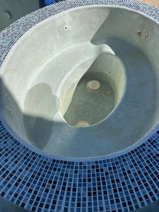 A close look at a spa interior during a pool and spa renovation, featuring a newly finished interior 