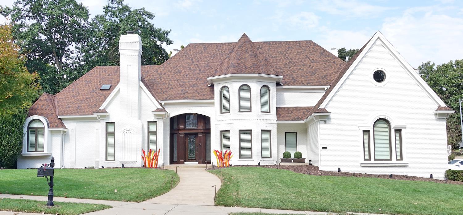 After image of exterior painting example completed by Elite Painting KC on a brick house.