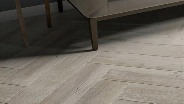 Wooden plank effect floor tiles in a herringbone pattern