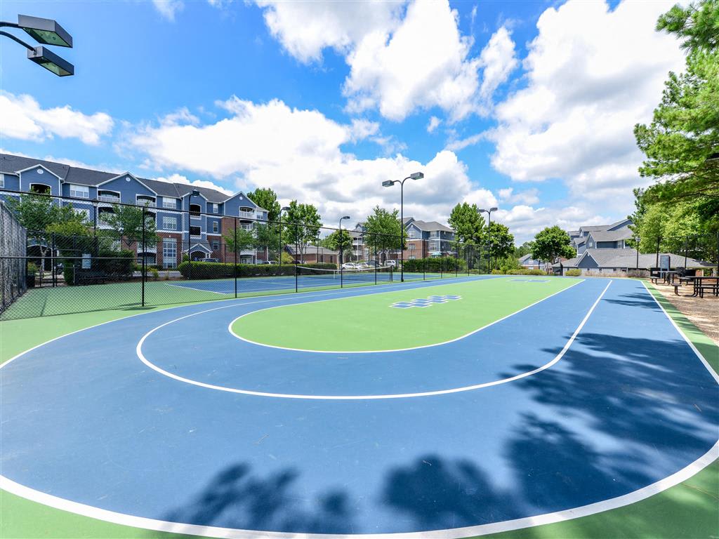 Lighted Tennis Court with Adjacent Sports Court at Sugarloaf Crossing Apartments