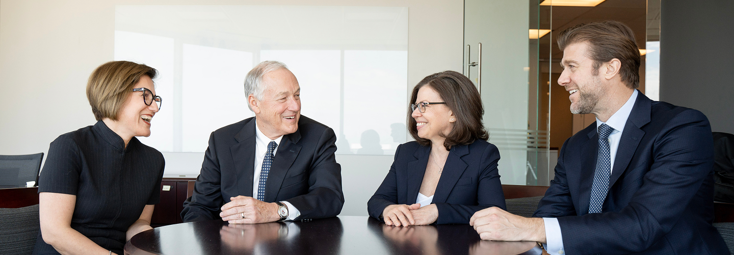 The Eastmure Thompson Wealth Advisory team around a boardroom table.