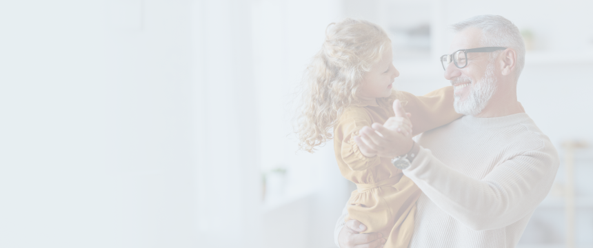 Grandfather dancing with his young granddaughter.
