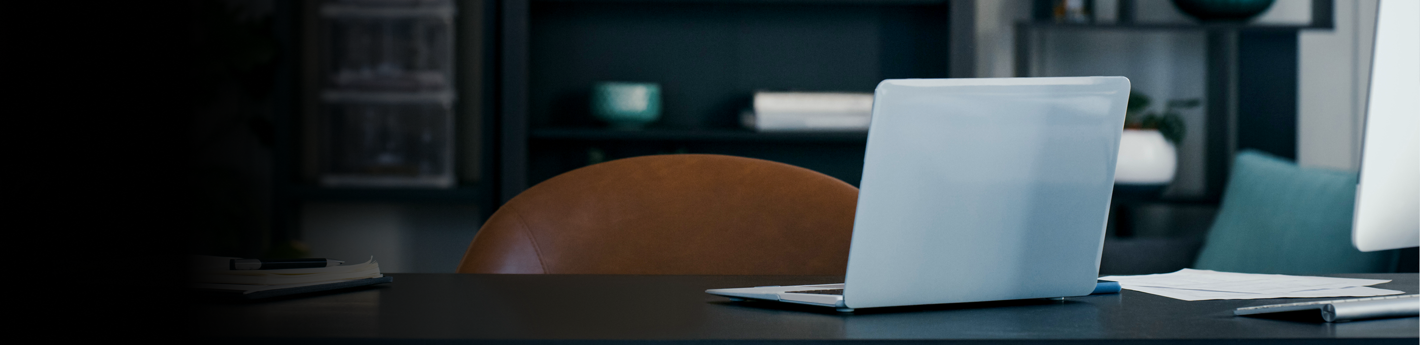Laptop on a table in an office.