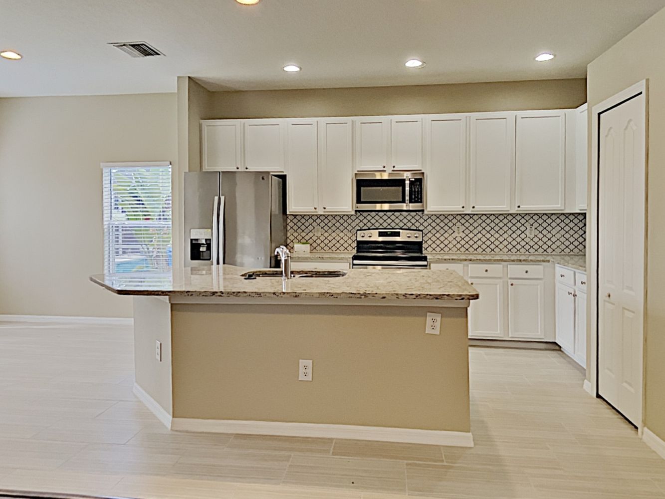 Updated open-concept kitchen and stainless steel appliances at Invitation Homes Tampa.