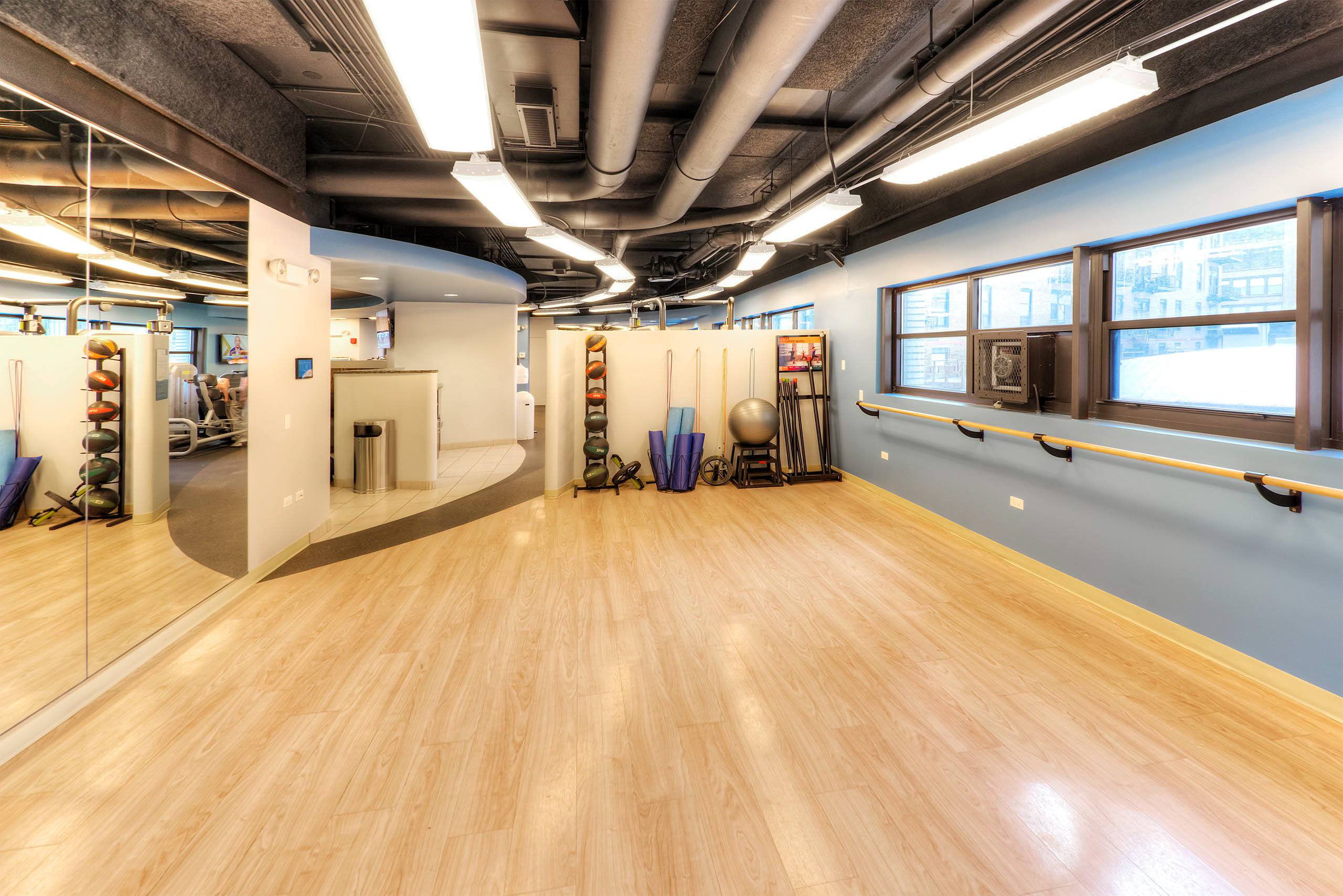 Studio space with wood floors and wall barre 