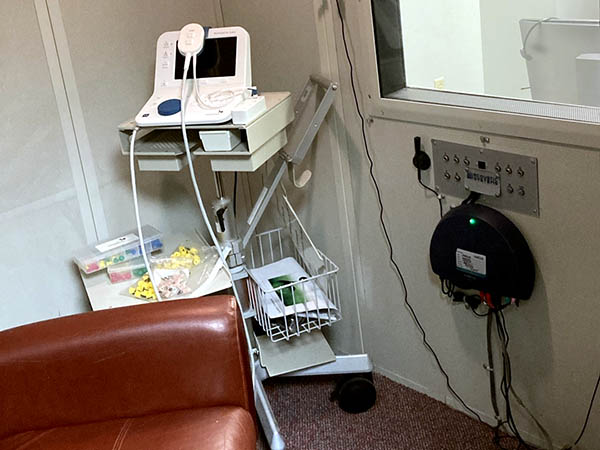 Interior photo of the hearing testing booth for AudioNova hearing clinic in Anderson, IN