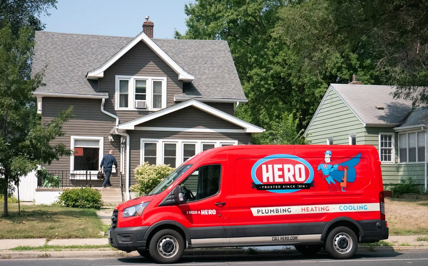 Hero: Plumbing, Heating, Cooling, Drains, Ducts & Electrical van outside of the house