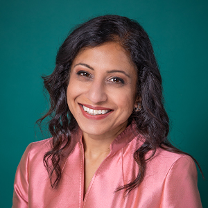 Female doctor smiling in front of a teal blue backdrop. Purvi P. Bhandari, MD, FAAP Springfield (217)960-8193