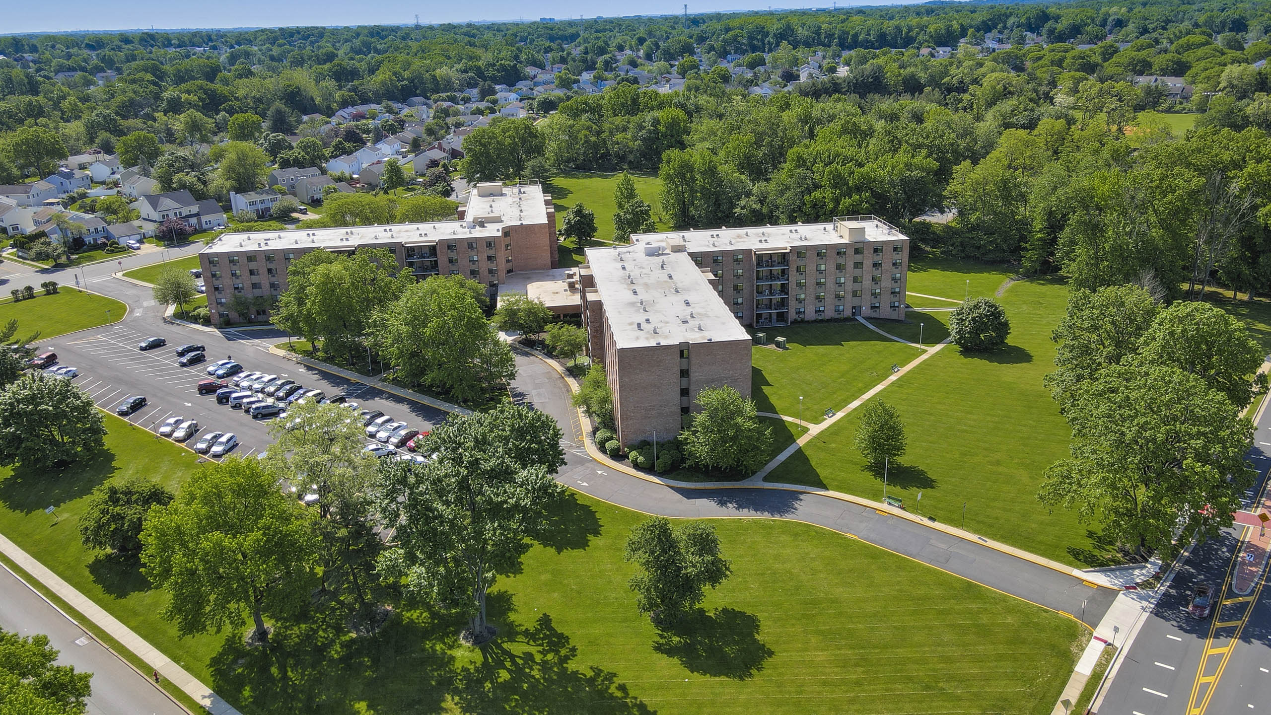 A large building with a parking lot in front of it.