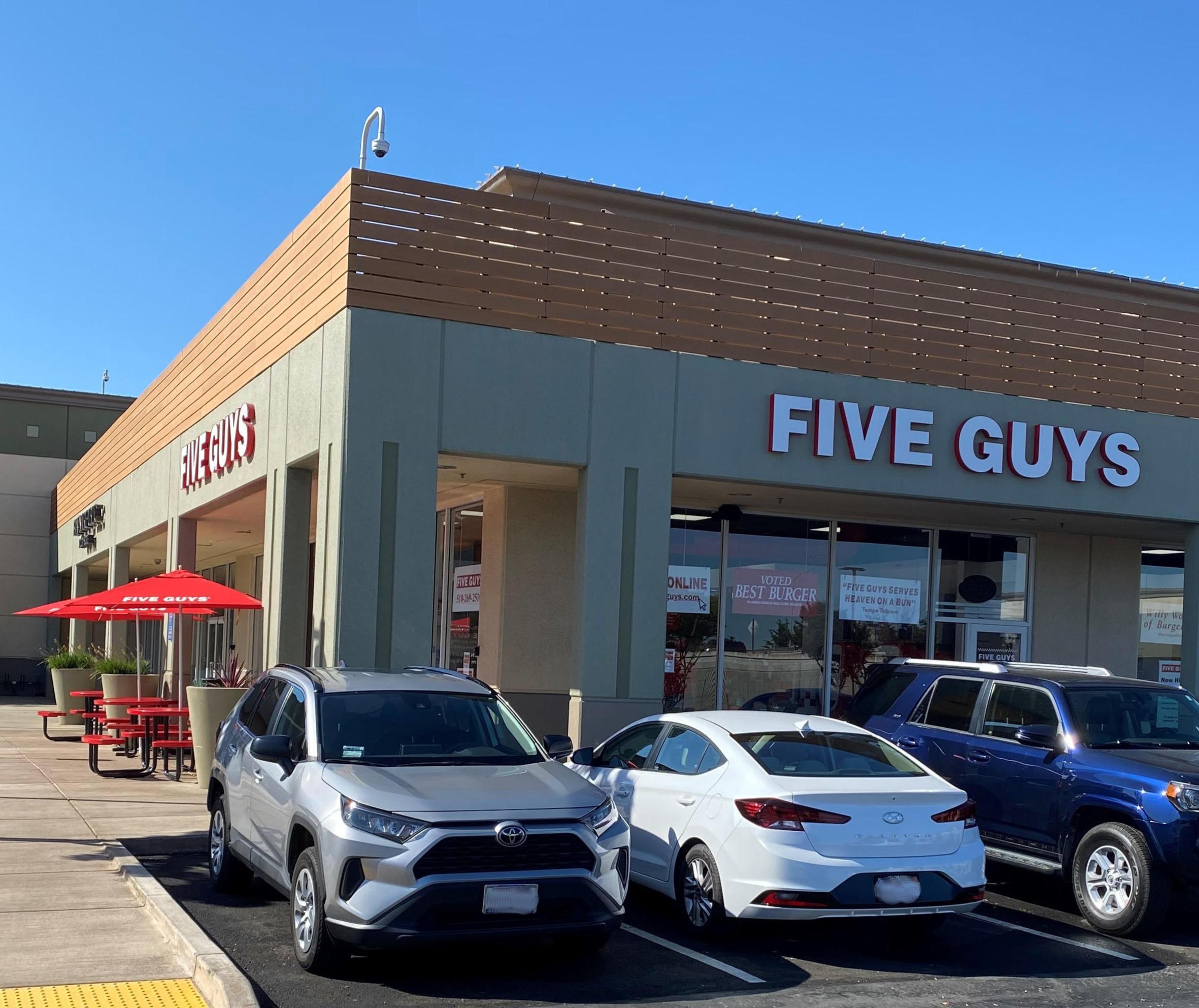 Exterior photograph of the entrance to the Five Guys restaurant at 1201 Marina Boulevard in San Leandro, California.