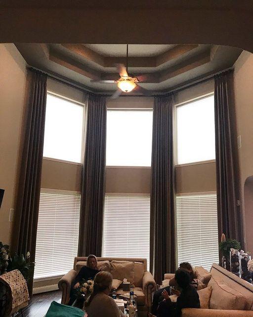 Looking for a way to make a statement? This Katy home will inspire you. Check out our awesome floor-to-ceiling Draperies paired with Wood Blinds! #BudgetBlindsKatySugarLand #CustomDraperies #WoodBlinds #FreeConsultation #WindowWednesday