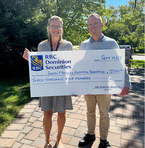 Daryl Knudson presenting a giant cheque to Leah Walker in support of the South Muskoka Hospital Foundation.