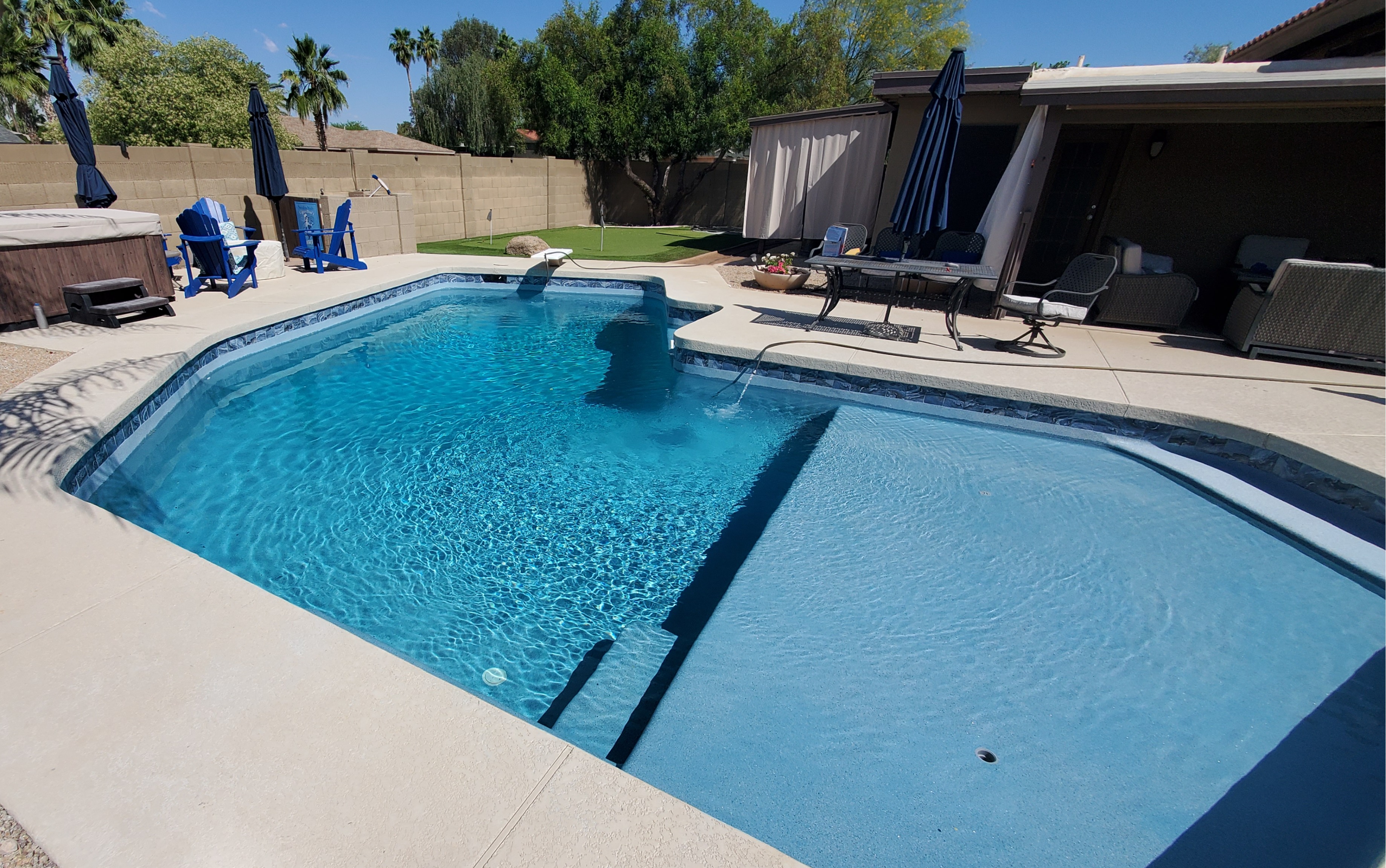 ✨ Custom Pool Remodel in Gilbert with Oversized Baja Ledge & PebbleTec Finish ✨

This stunning custom pool remodel in Gilbert features an oversized Baja walkout ledge, perfect for sunbathing and lounging in the water. The luxurious Pebble Tec finish enhances both beauty and durability, while elegant travertine tile adds a high-end touch to the pool’s design. Designed for both relaxation and style, this modern pool upgrade creates a resort-style backyard retreat in the heart of Arizona.