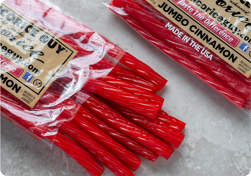 Close-up of The Licorice Guy's Jumbo Cinnamon licorice, featuring vibrant red twisted pieces fresh from the bag. Made in the USA and naturally and artificially flavored.
