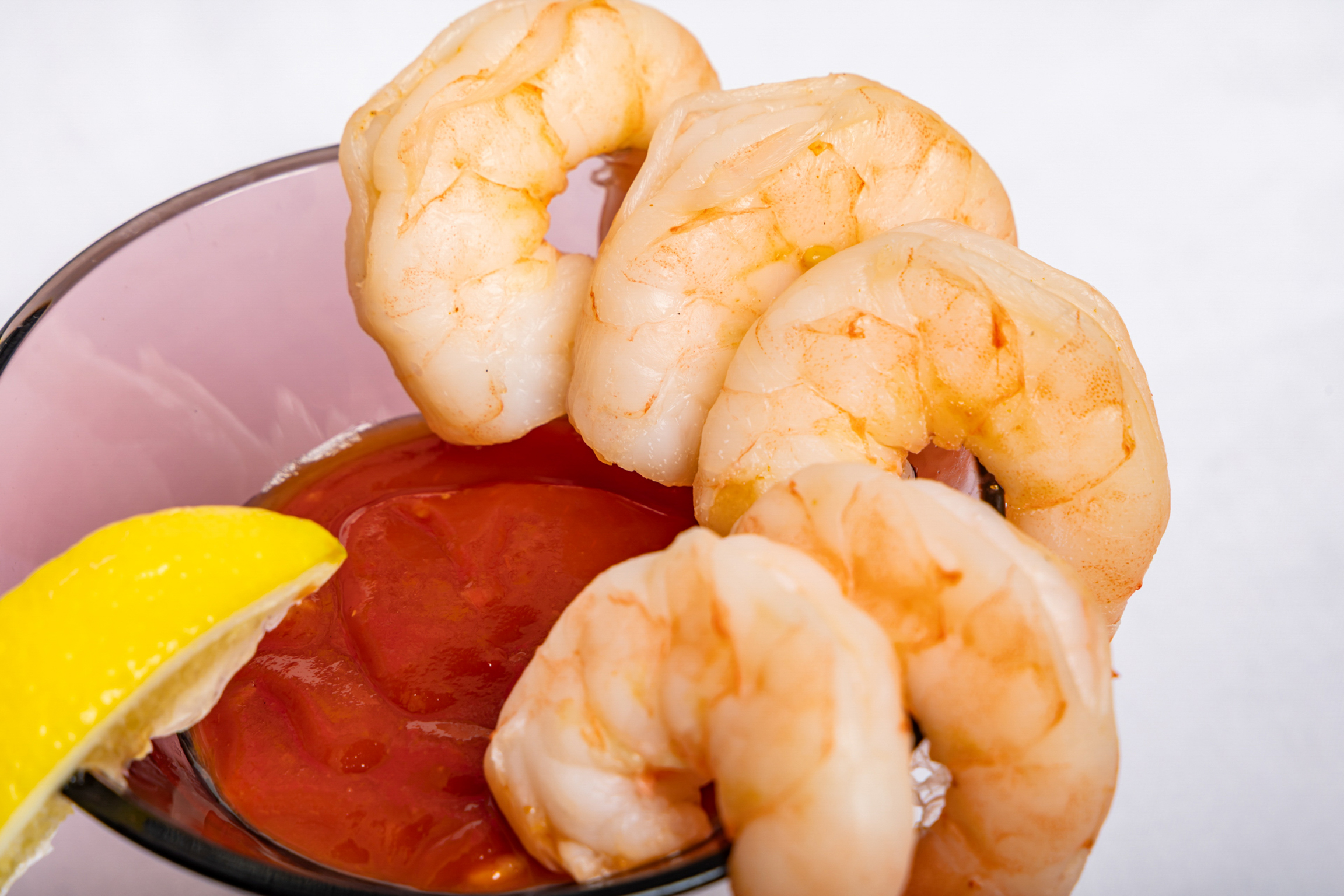 Chilled, perfectly cooked shrimp served with a zesty cocktail sauce for a refreshing bite.