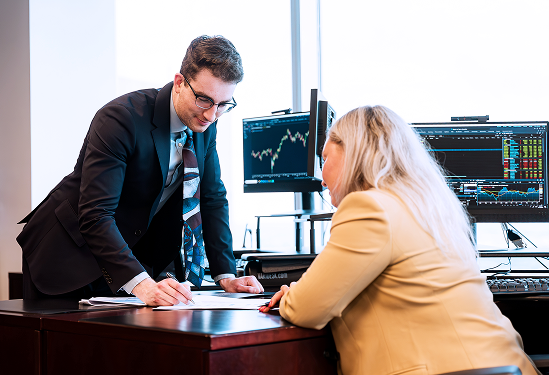 Two members of the Rae Family Wealth team collaborating in an office.