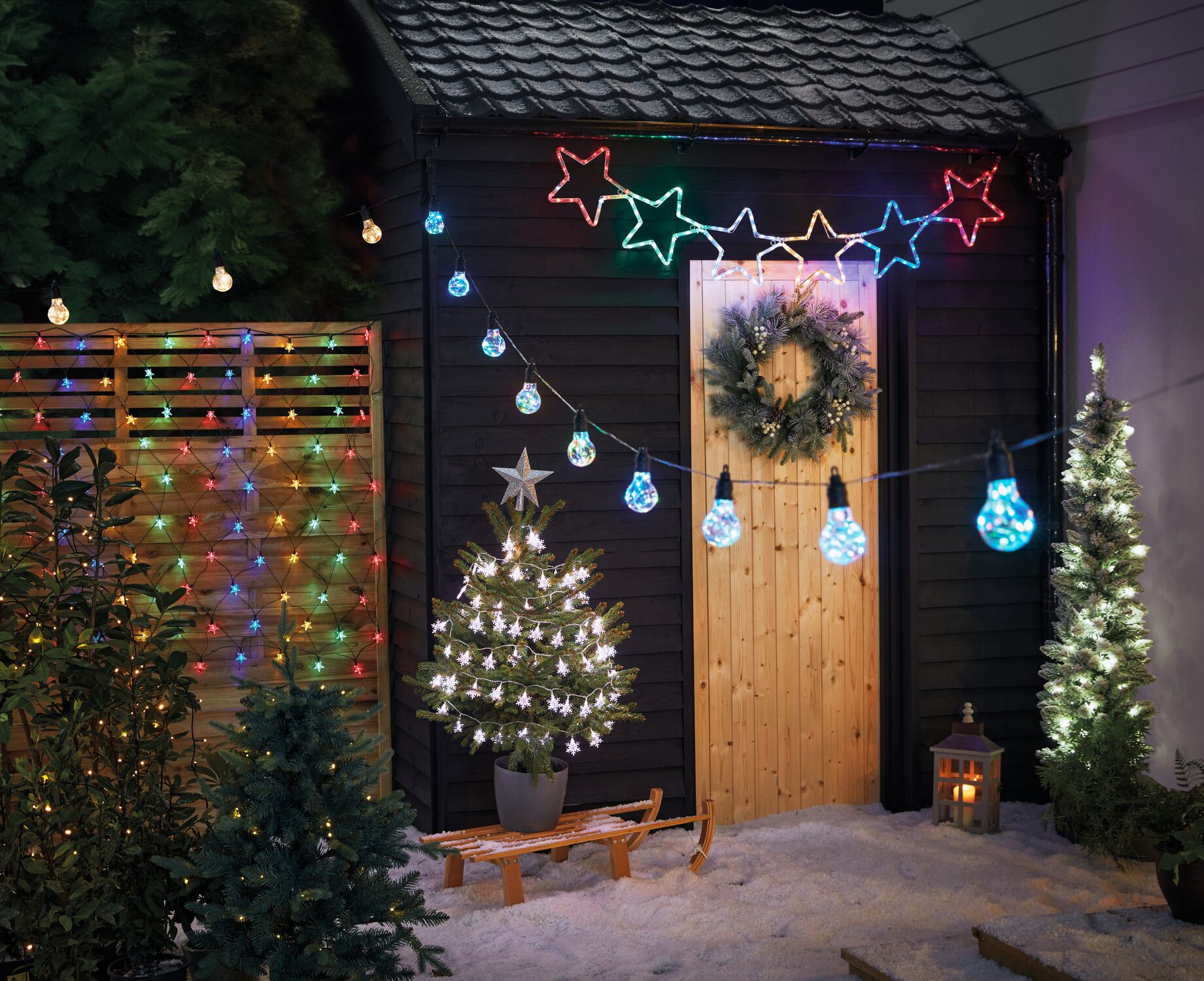 A mixture of outdoor Christmas lights including tree lights and netted lights
