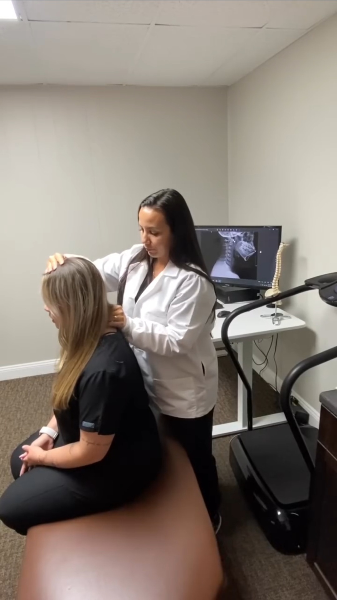 Chiropractor Dr. Duerto adjusting neck.